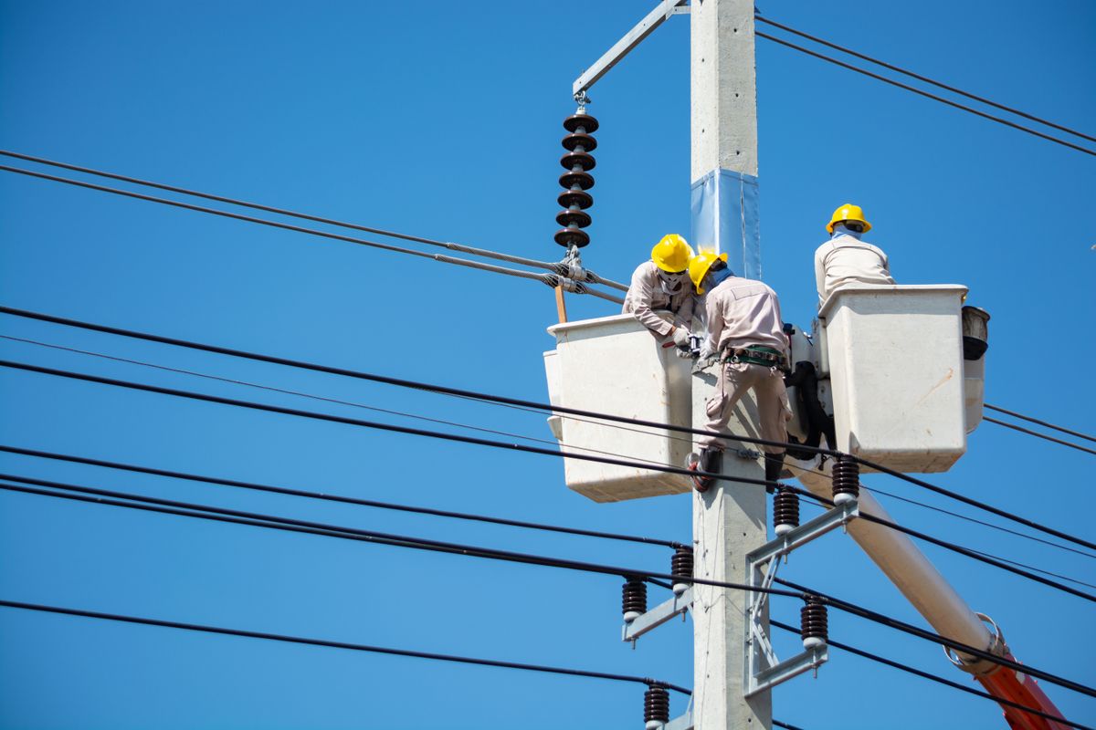 Line crew working from a bucket truck on a power pole